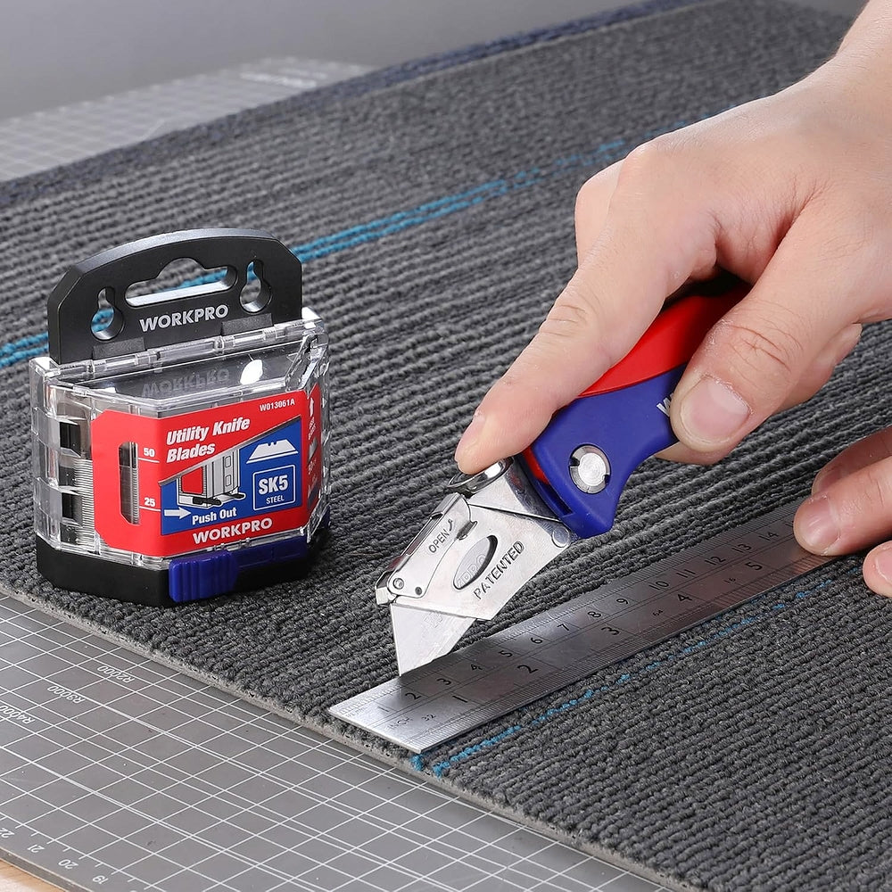 Utility knife blade pack and cutter blade cutting fabric on a marked surface