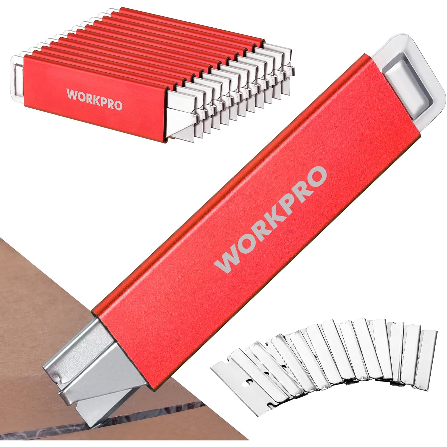 Red WORKPRO retractable box cutter extended with extra razor blades beside it