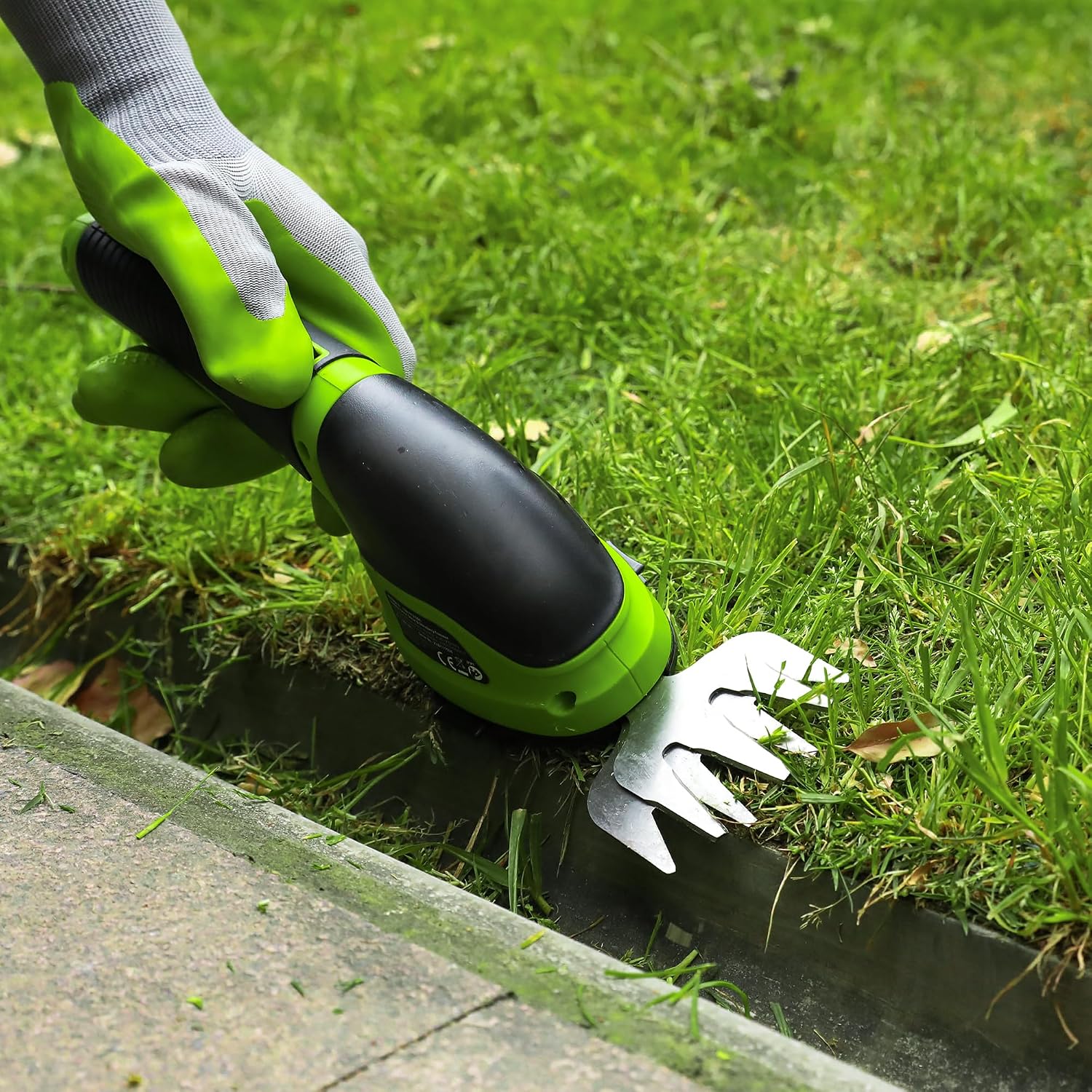 Grass shear blade attachment with serrated metal cutters for trimming along edges.