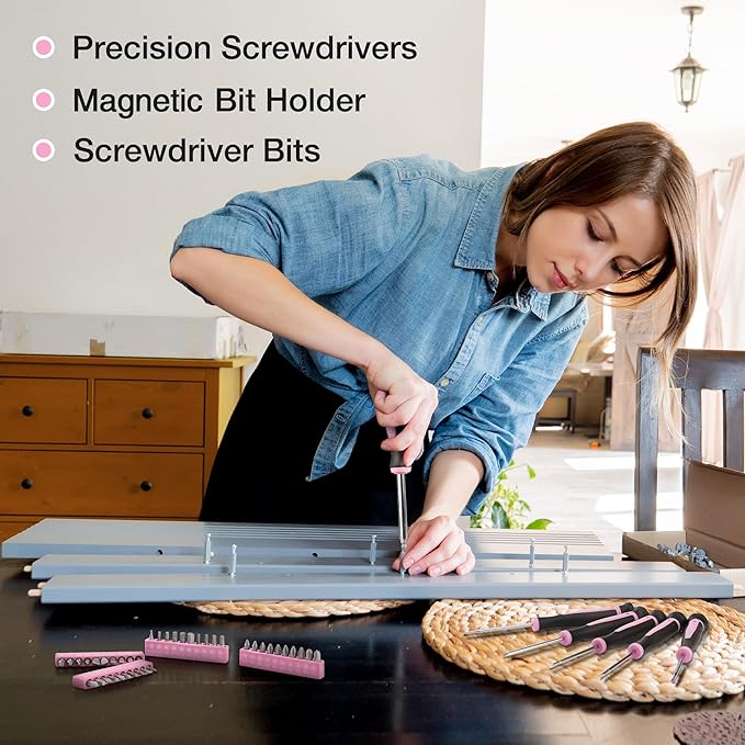 Pink precision screwdriver set with magnetic bit holder and screwdriver bits on table