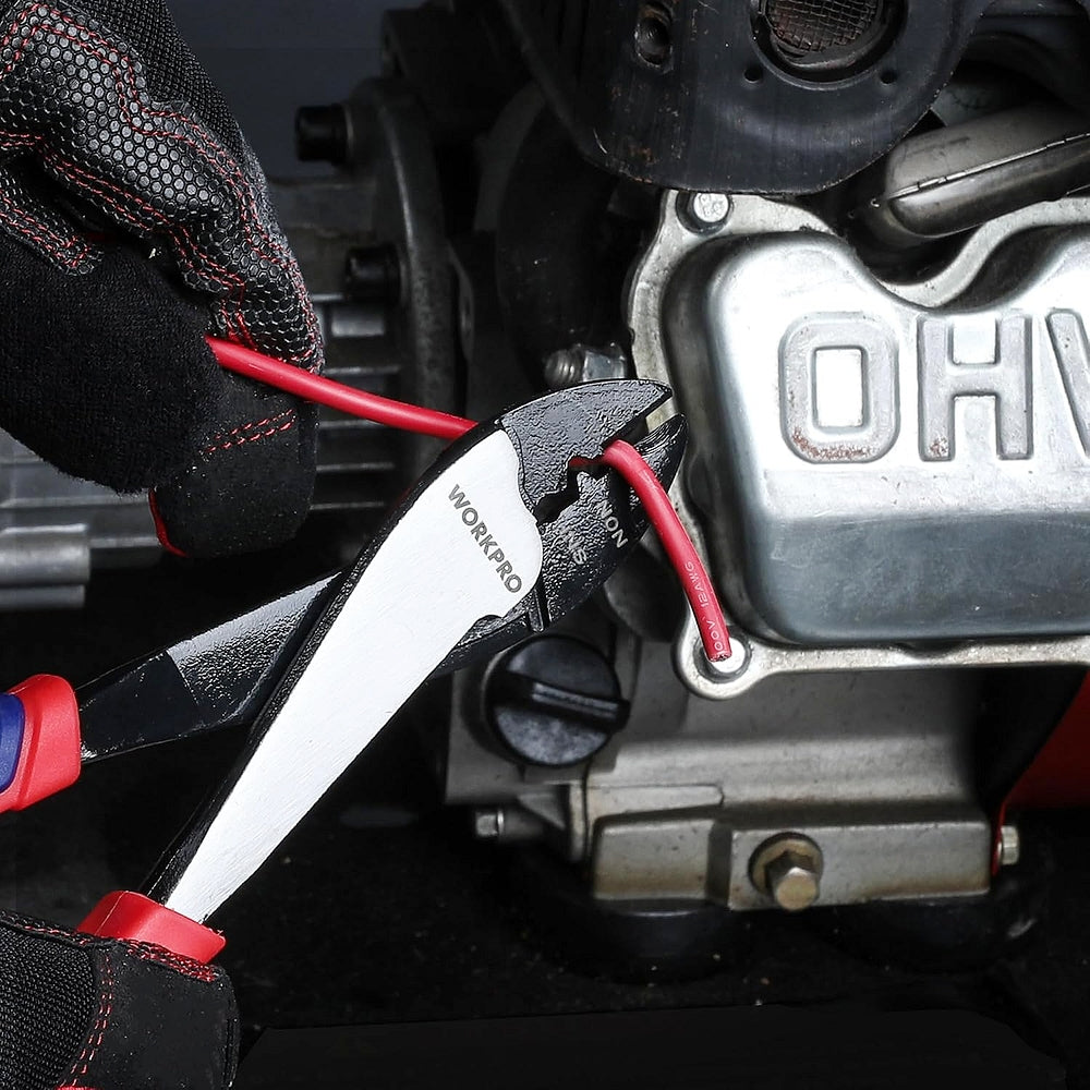 Wire cutter crimper holding a red wire near engine components