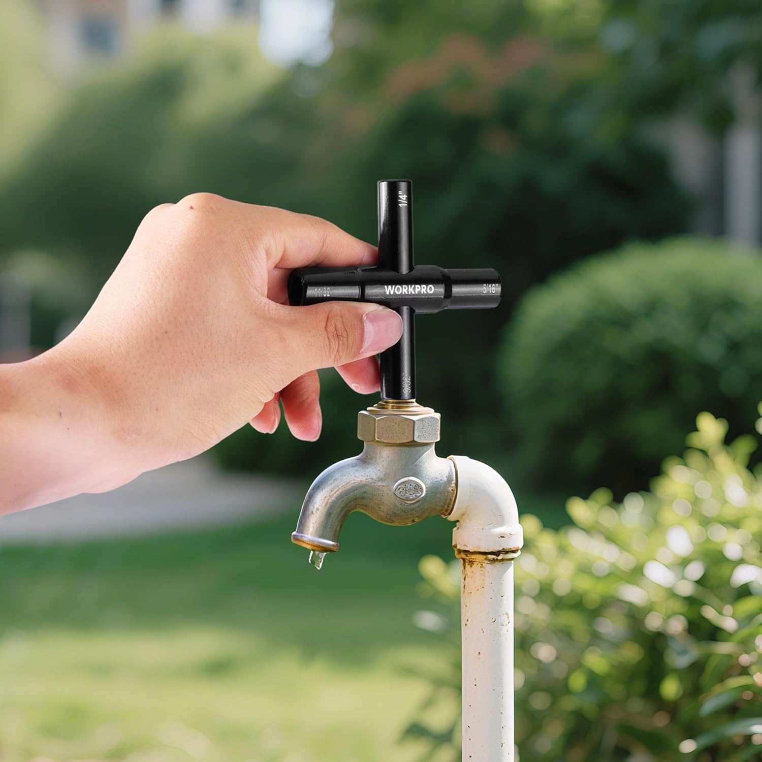 WORKPRO 4-way water key wrench on brass sillcock valve, handheld for turning