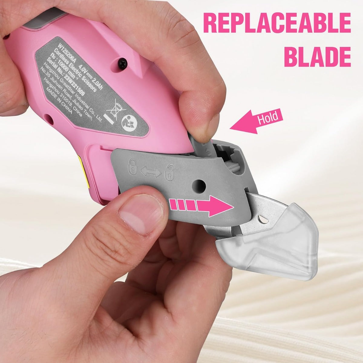 Pink cordless electric scissors with replaceable blade, latch and blade release shown