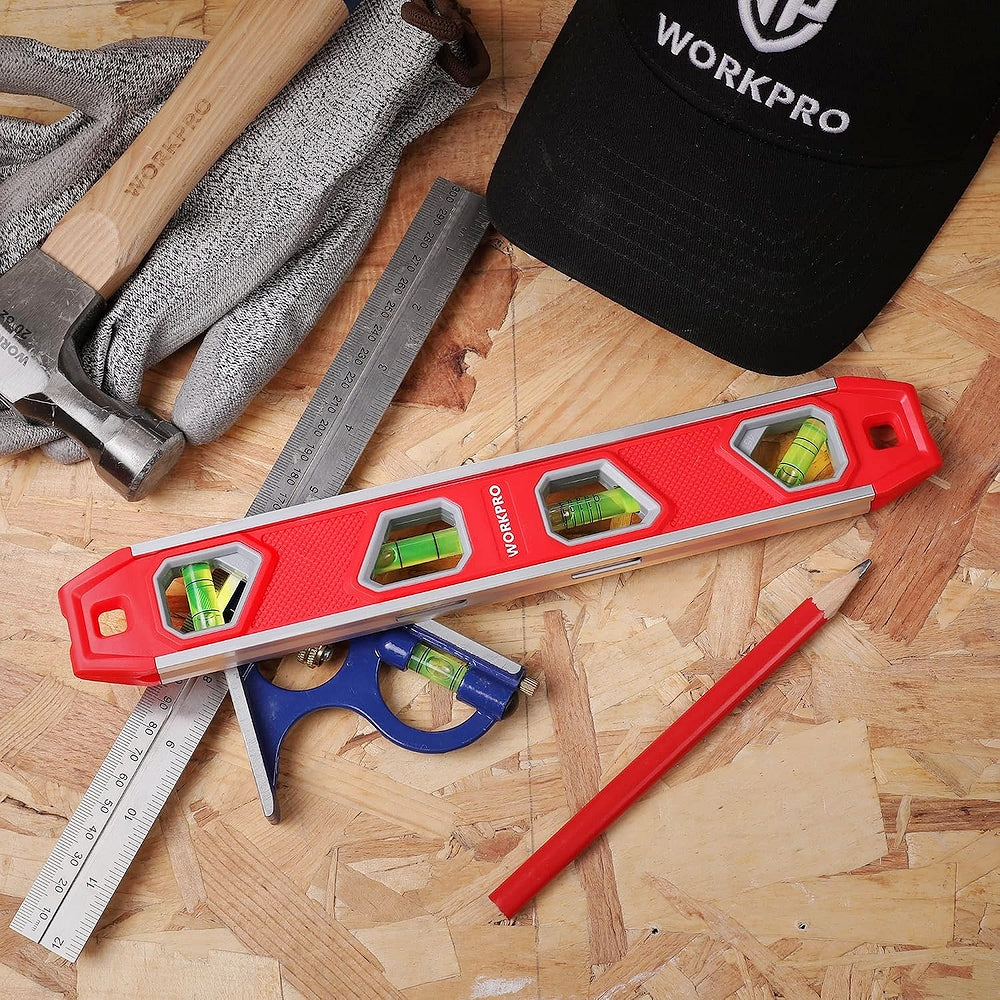 Red aluminum magnetic torpedo level with 4 green bubble vials on wood