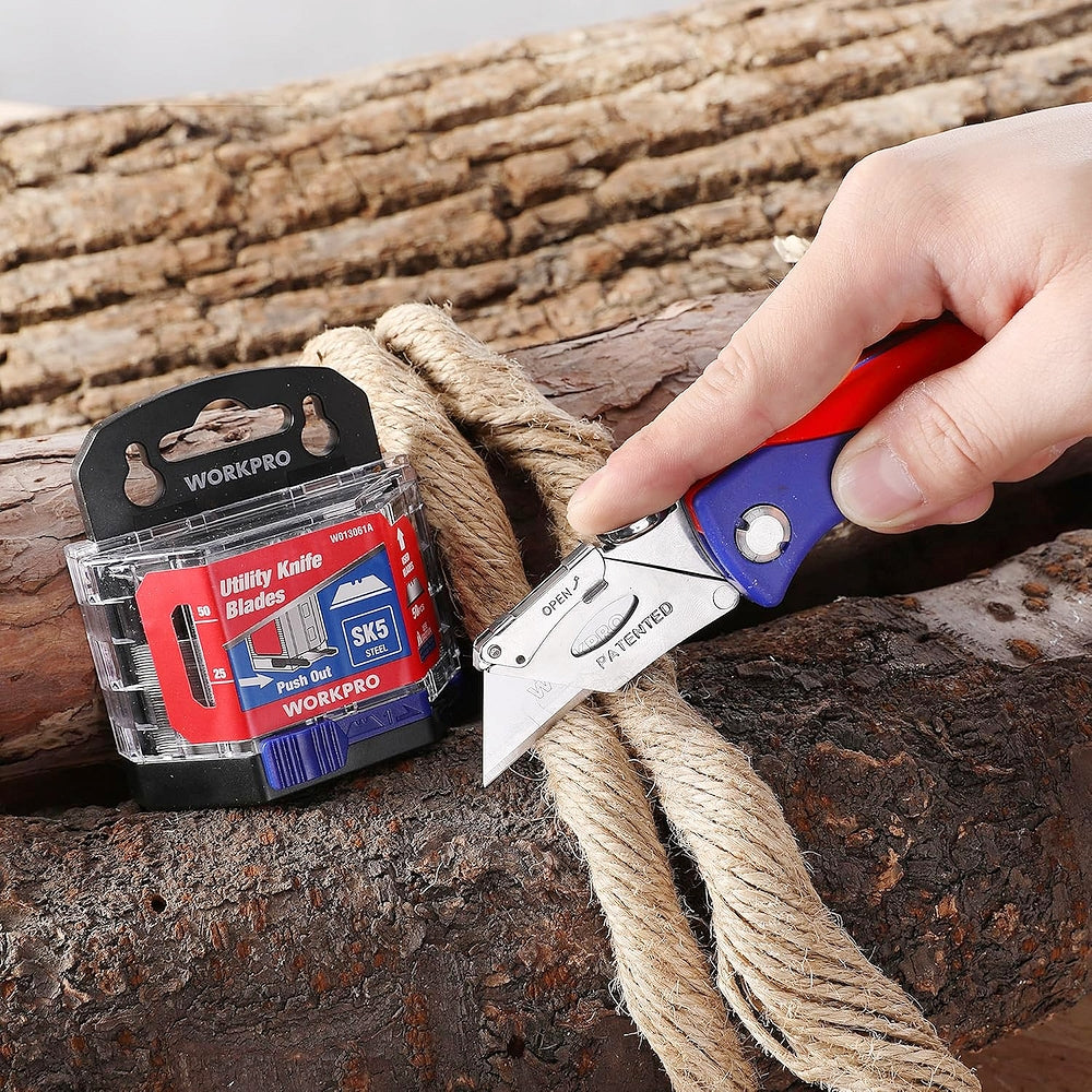 Utility knife blade pack and cutter blade trimming rope on a wood log