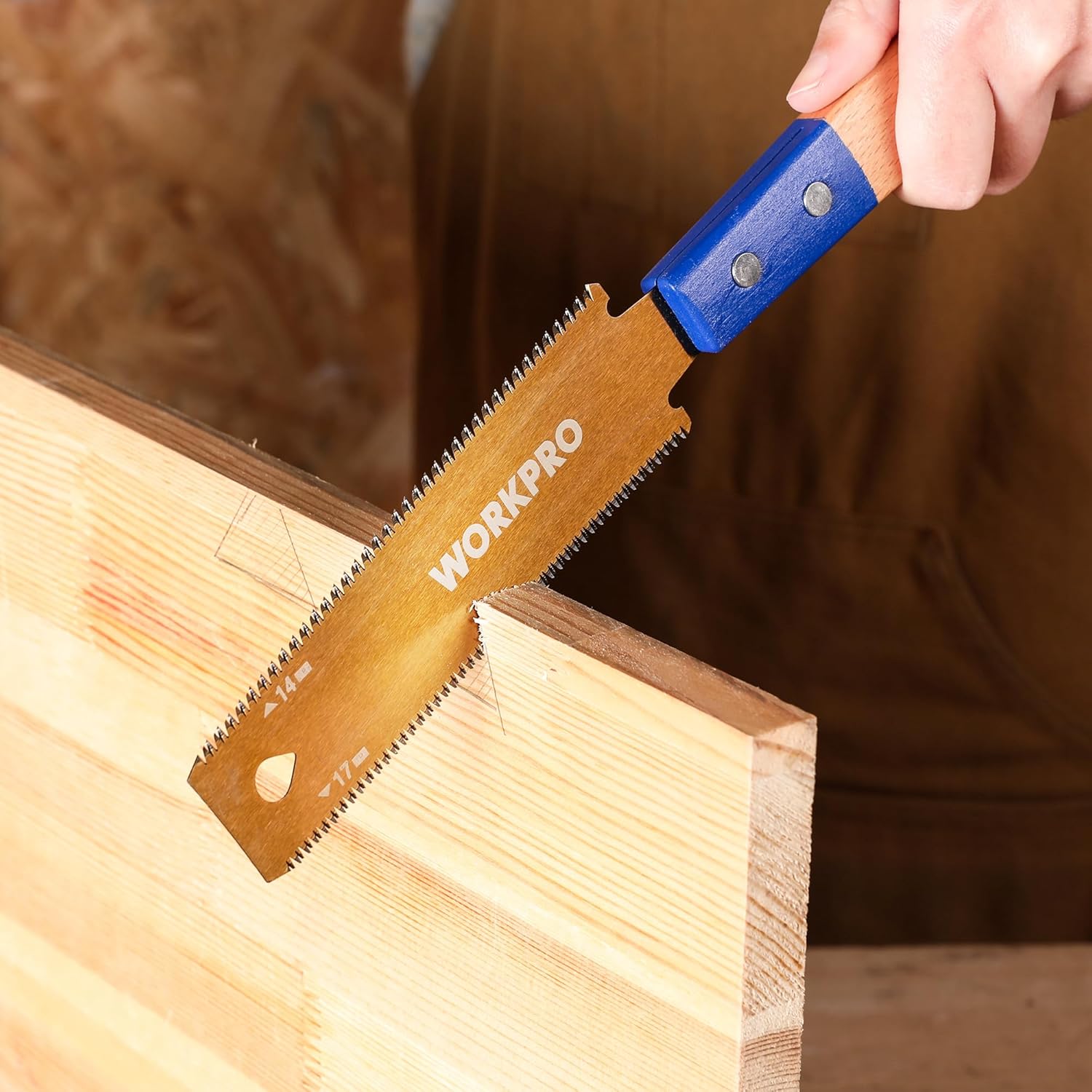 Japanese pull saw cutting a wood board; blue grip beech handle with toothed blade