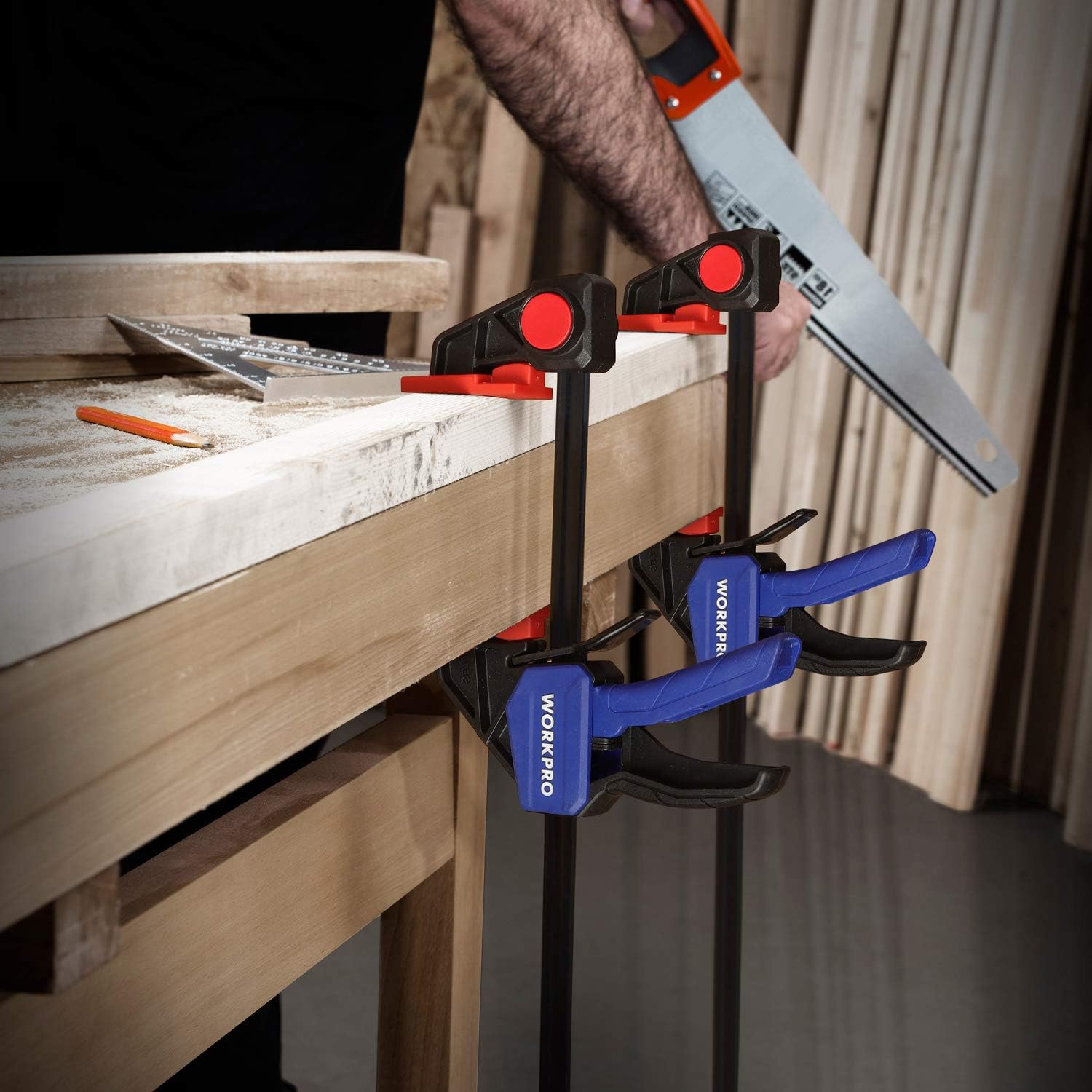 WORKPRO F clamps holding wood boards; blue handles and red pressure pads
