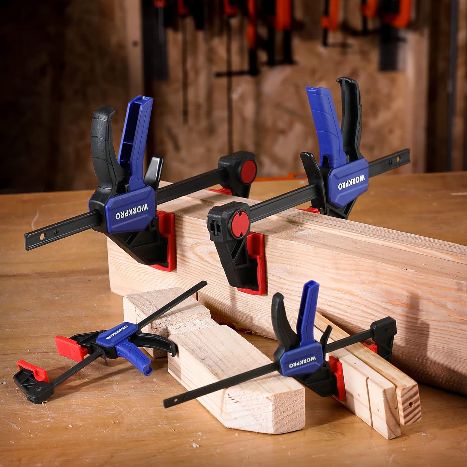 WORKPRO mini bar clamps securing wood pieces in a workshop setup