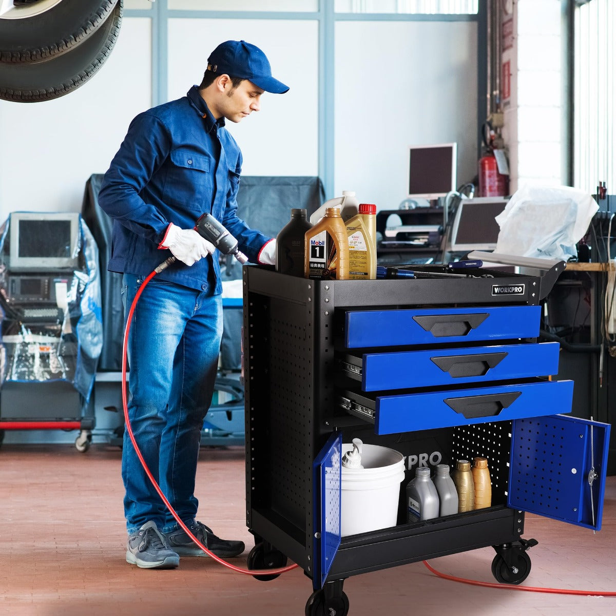 WORKPRO rolling tool chest in workshop with open drawers and cabinet, on four wheels