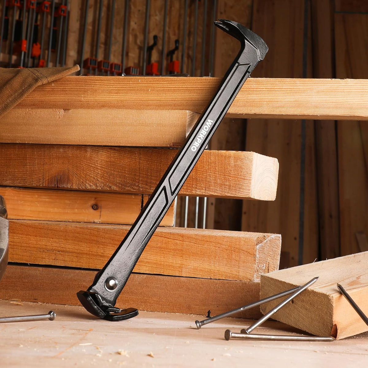 Rocking nail puller pry bar lifting nails from wooden beams in a workshop