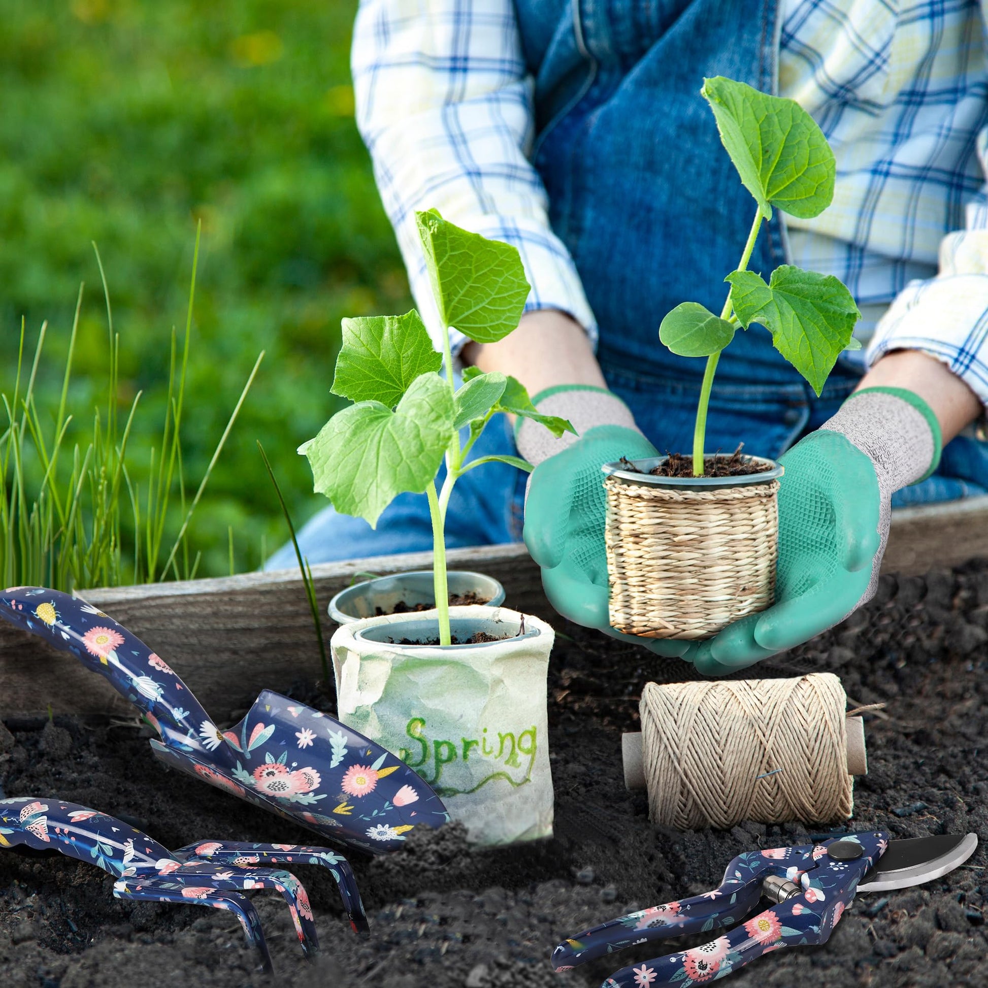 Turquoise-gloved hands holding seedlings with blue floral tools in potting soil
