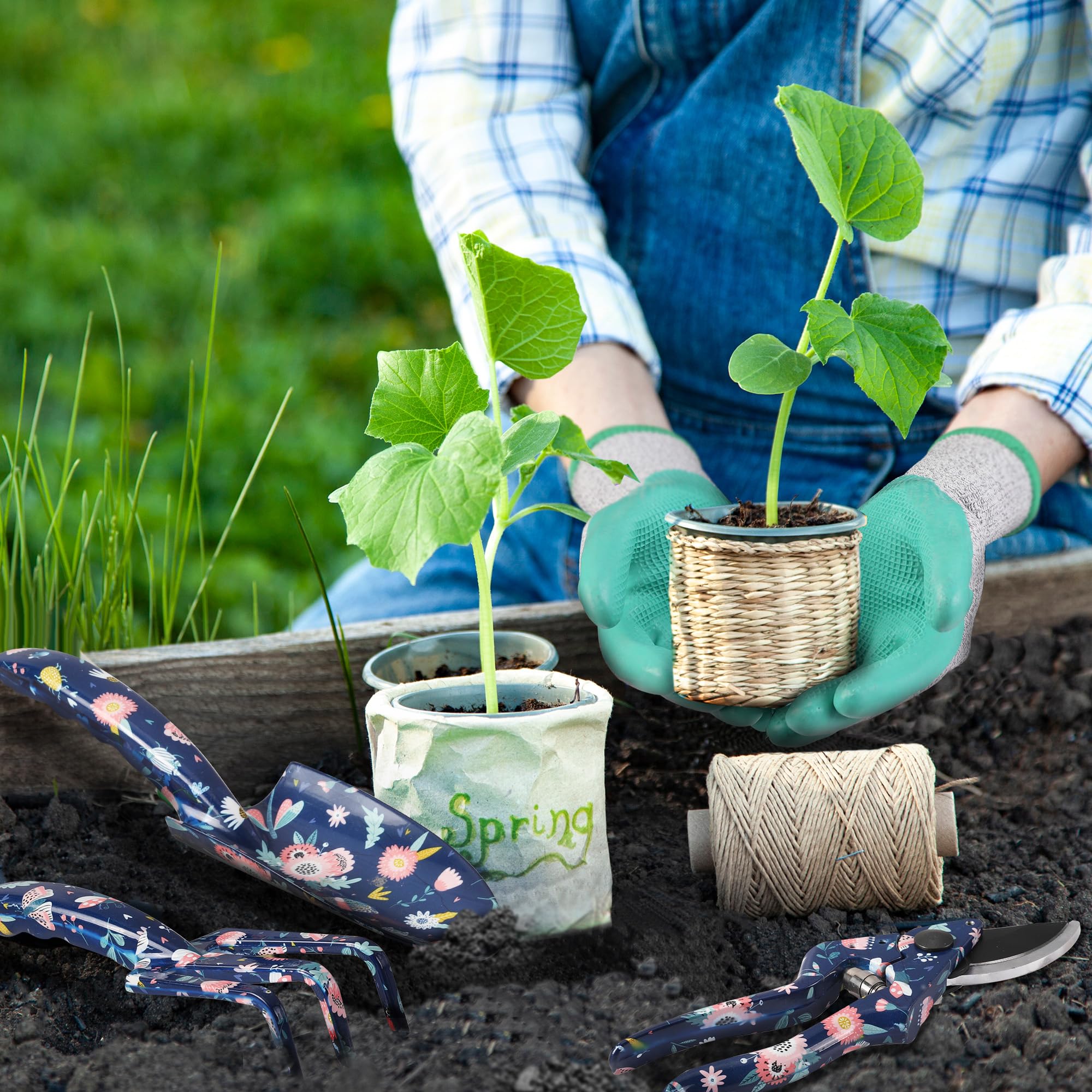 Turquoise-gloved hands holding seedlings with blue floral tools in potting soil