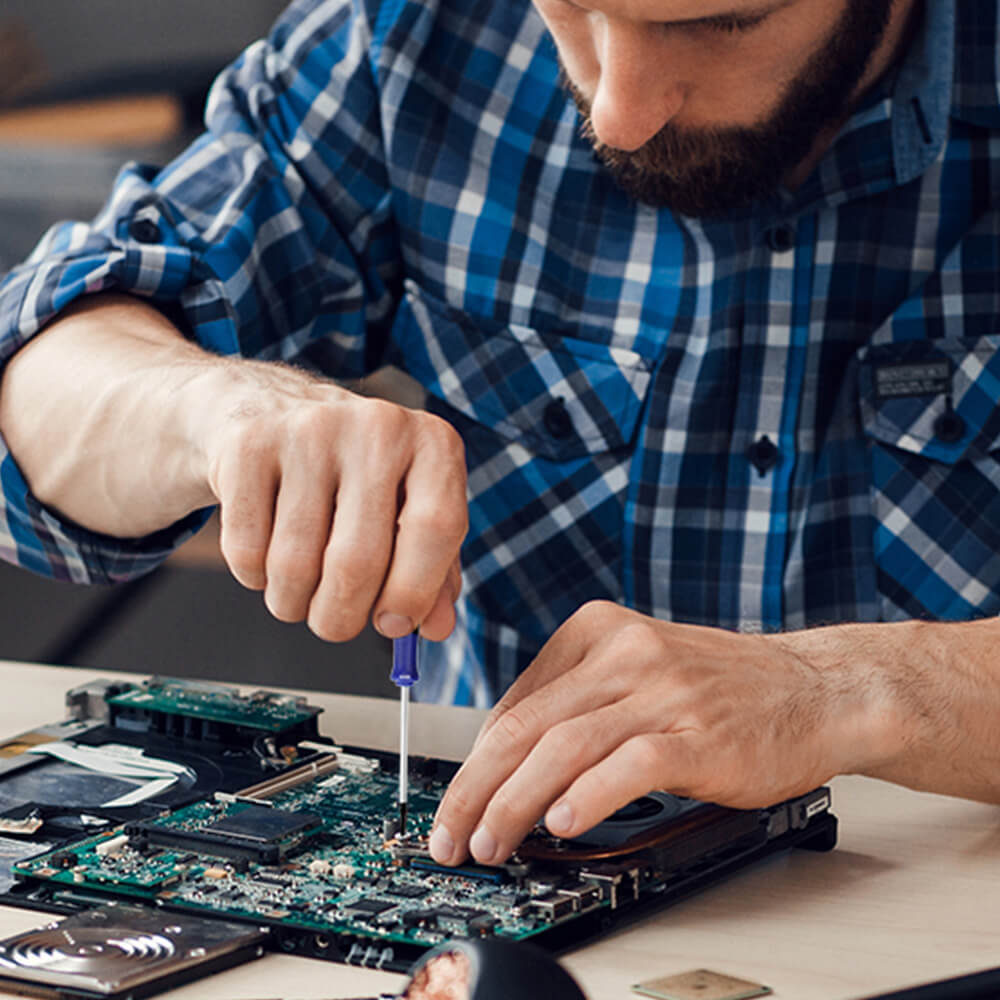 Technician repairing a circuit board with a screwdriver, innovation and quality in secure, durable electronics work