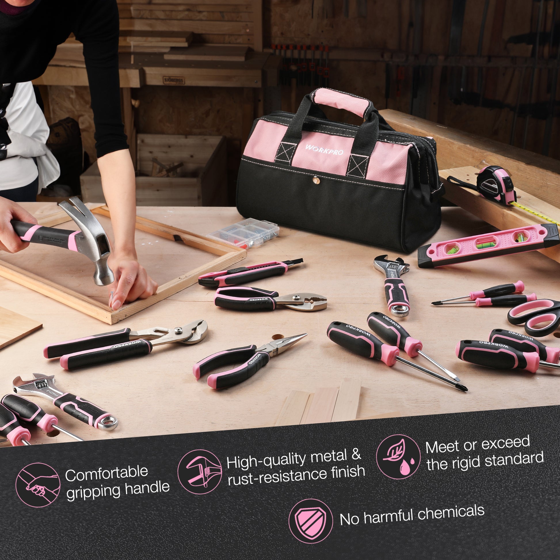 Pink-and-black tool bag with assorted hand tools arranged on a work surface