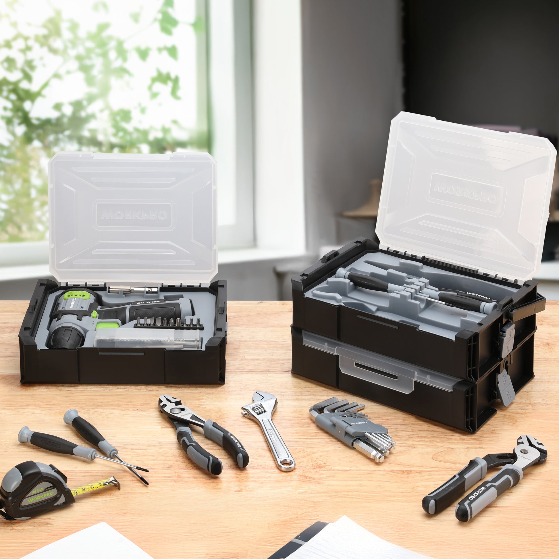 Open stackable tool boxes with cordless drill driver, bits, and tools laid out