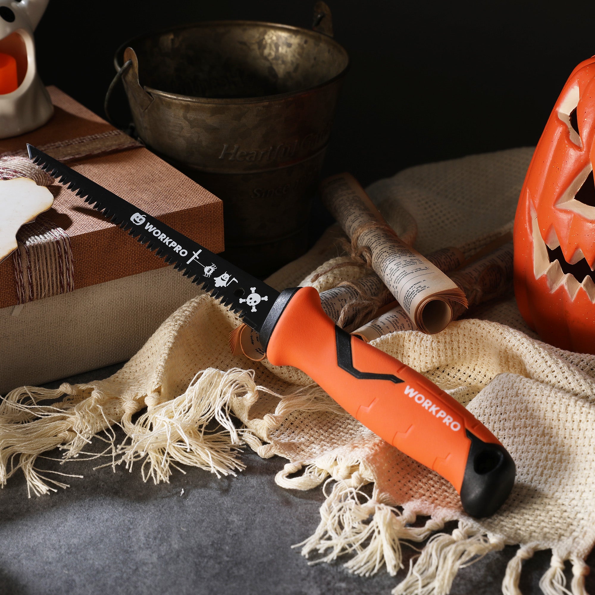 Close-up pumpkin saw with orange handle, black serrated blade on burlap fabric
