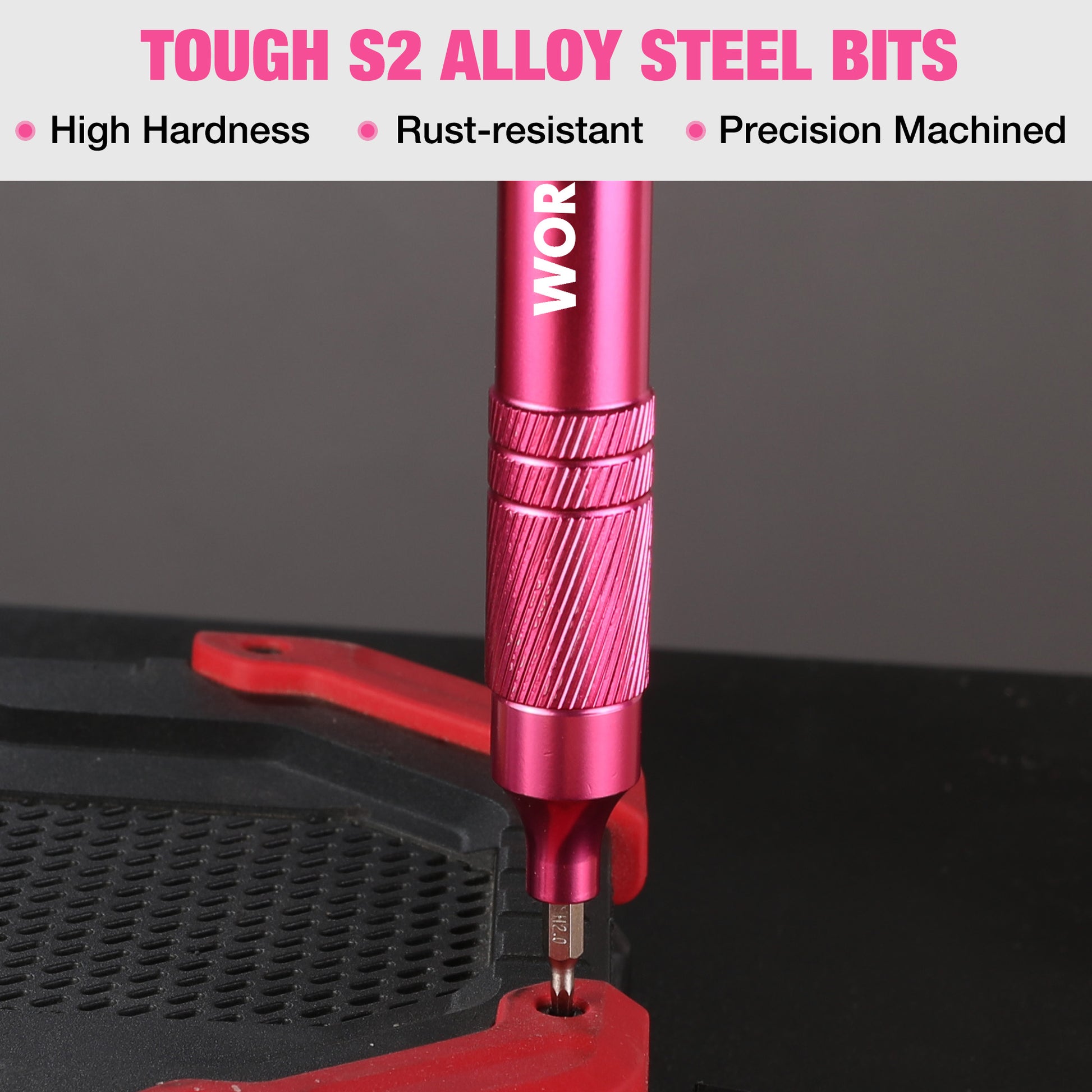 Pink precision screwdriver driving a screw with a pointed metal bit