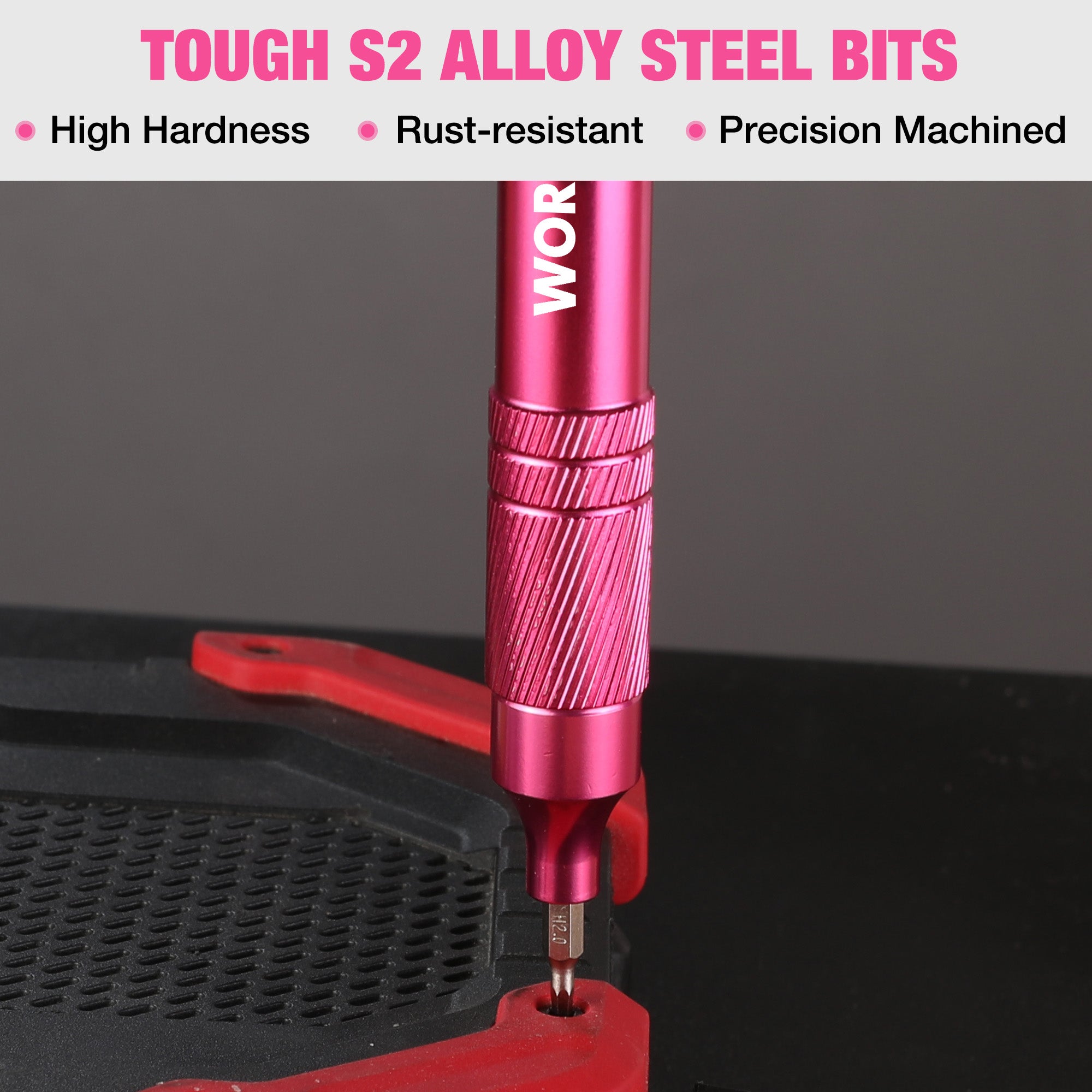 Pink precision screwdriver driving a screw with a pointed metal bit