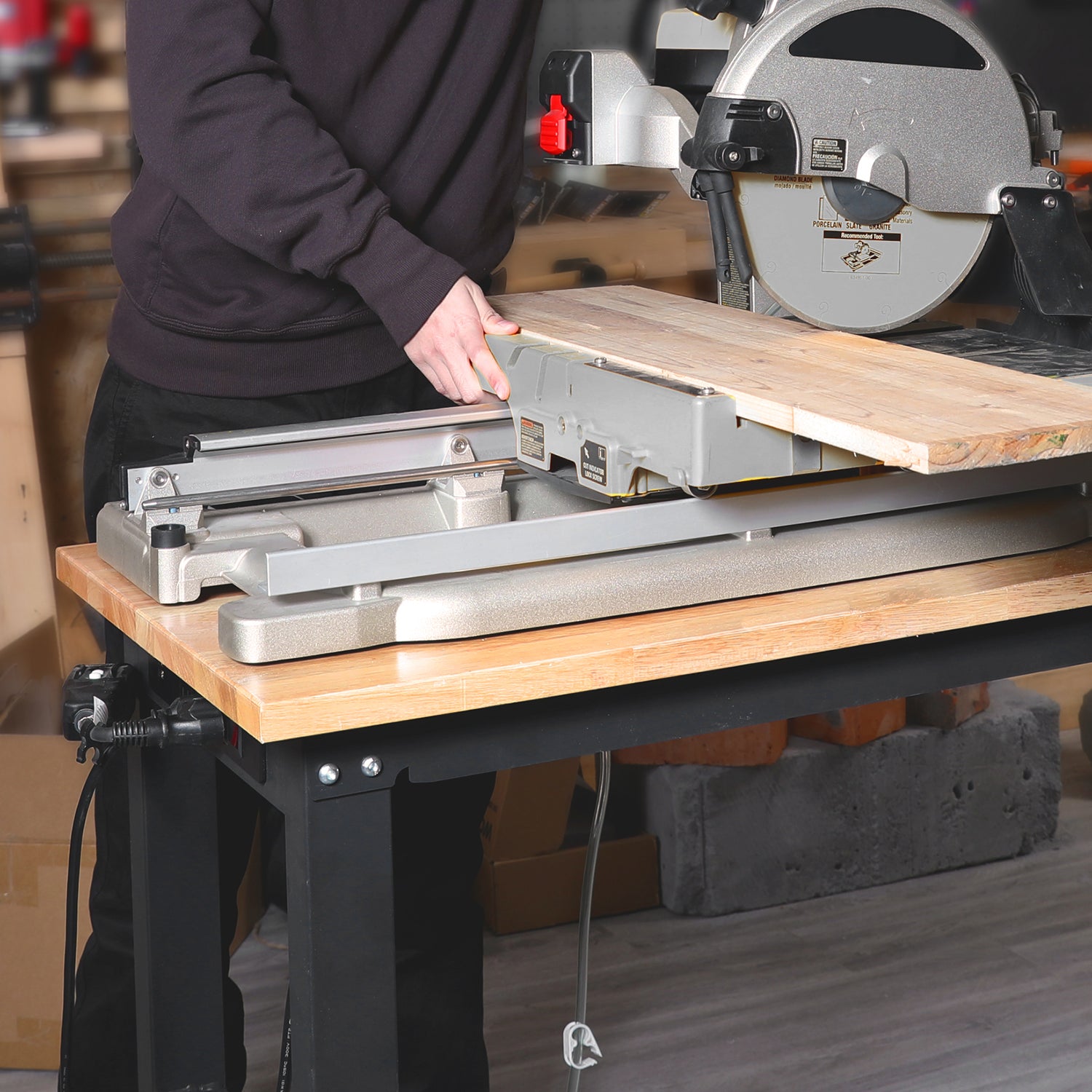 Workbench supporting a circular saw on a light wood tabletop with black frame