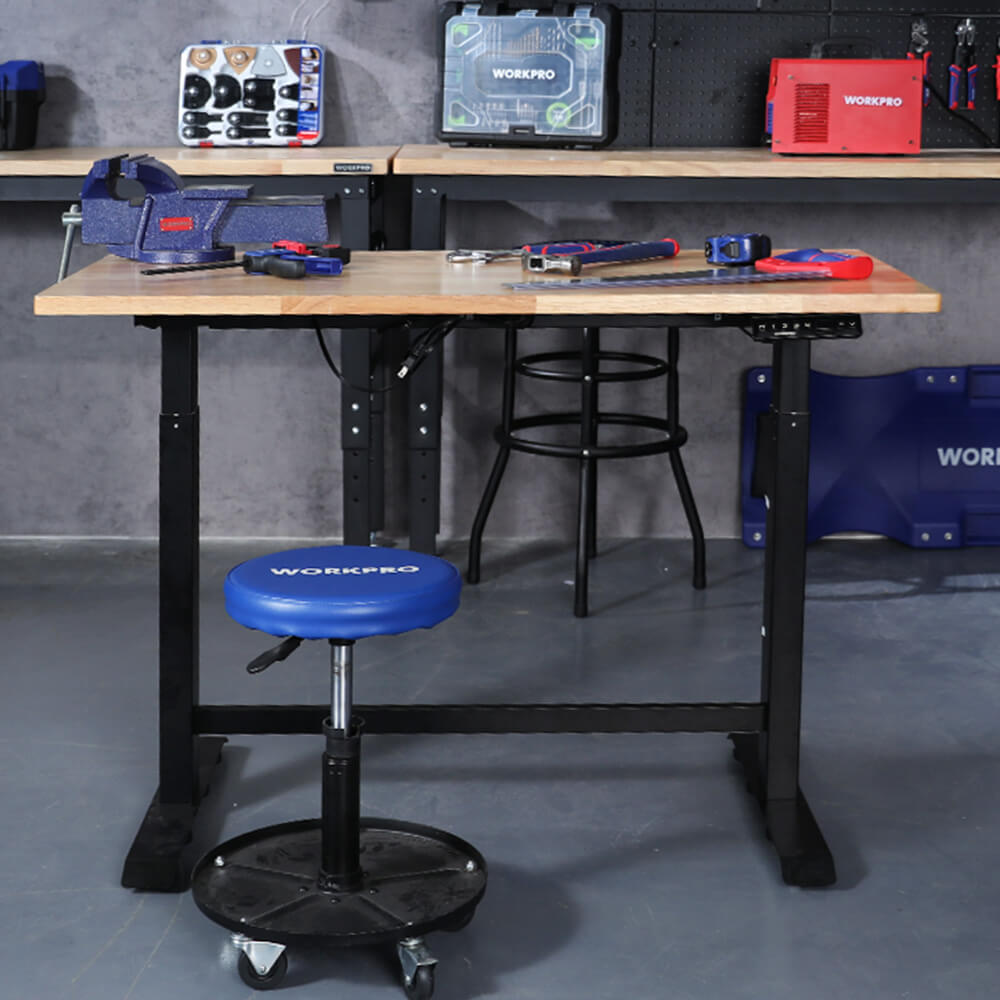 Workbench with tools and blue stool, with visible WORKPRO branding and organized storage on shelves