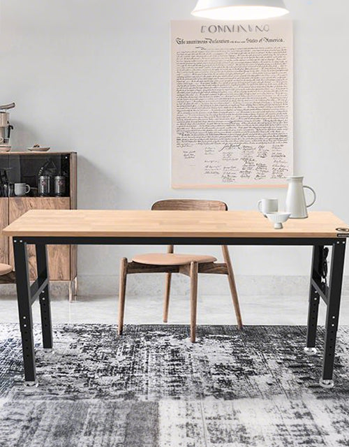 Modern dining table and chair in a bright room with a wall poster, innovation and quality visible