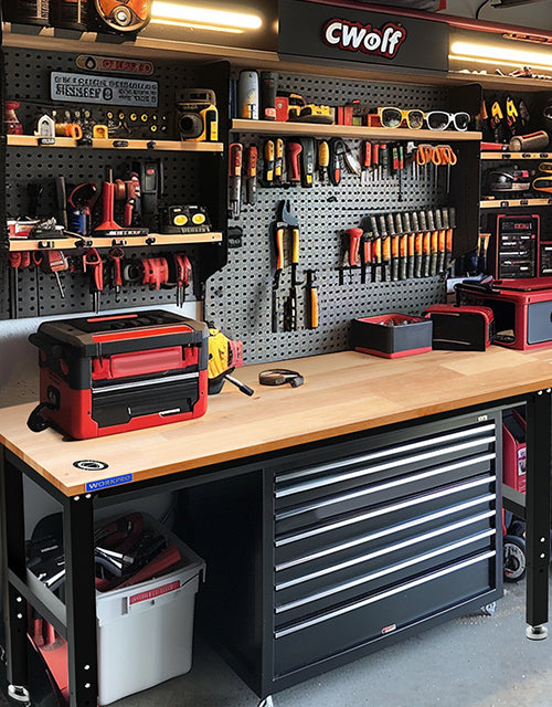 Tool workshop bench with red and black drawers, hand tools on pegboard, and innovation in organized storage