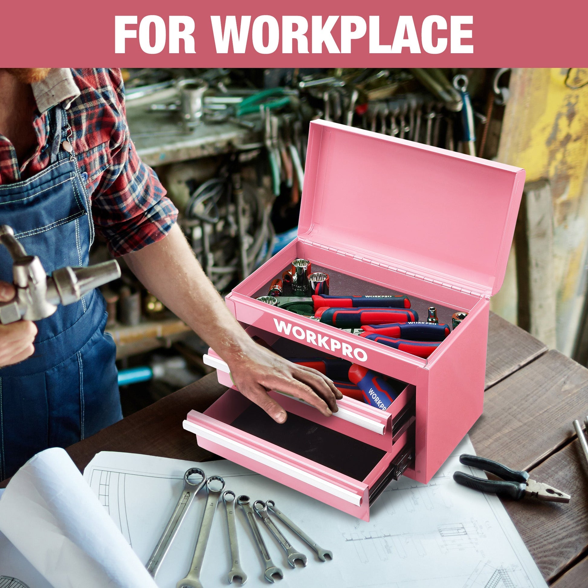 Pink mini tool box open on workbench, with two drawers and top storage compartment
