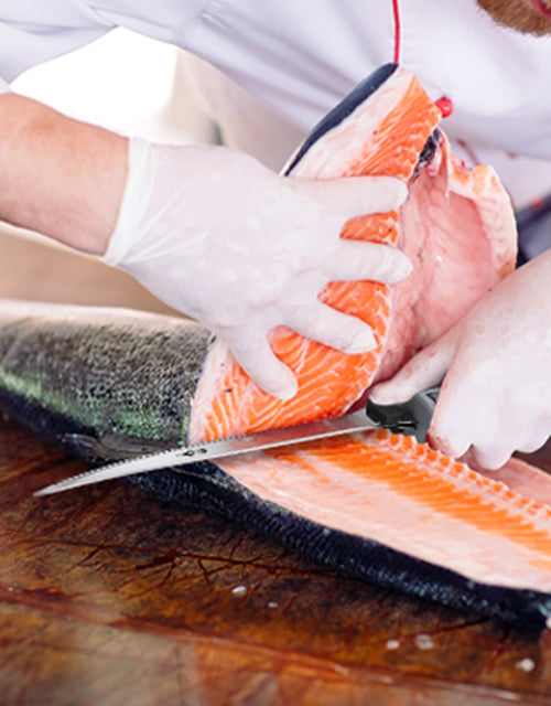 Gloved hands filleting salmon with a sharp knife, showing innovation and quality in precise cuts