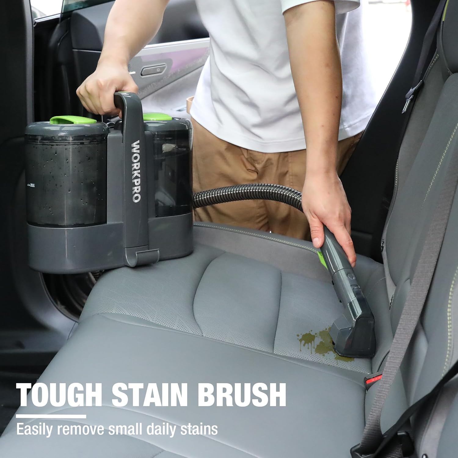 Portable upholstery spot cleaner with green hose and tough stain brush, black and gray