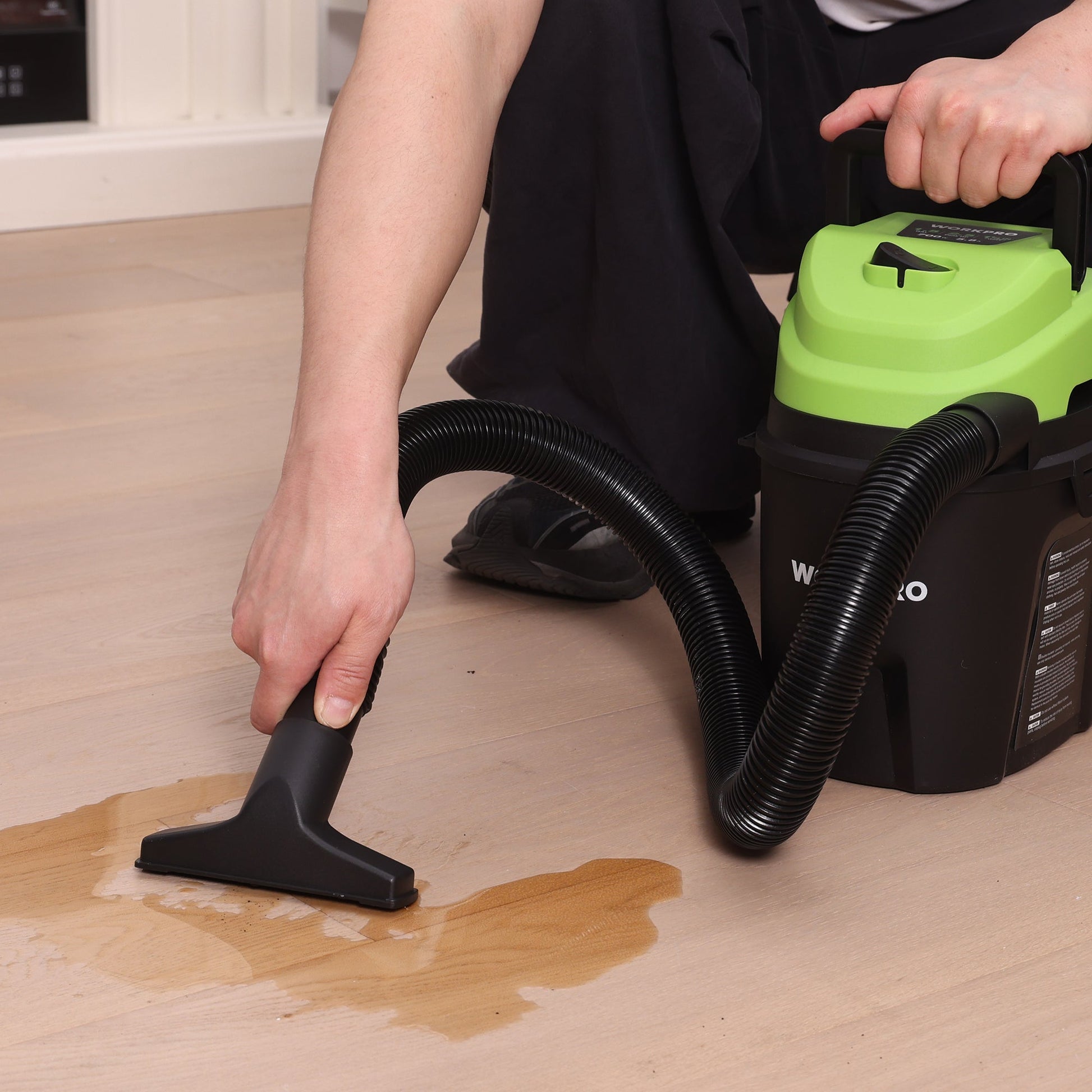 Portable wet/dry shop vacuum cleaner with floor nozzle and dual black hoses, green top