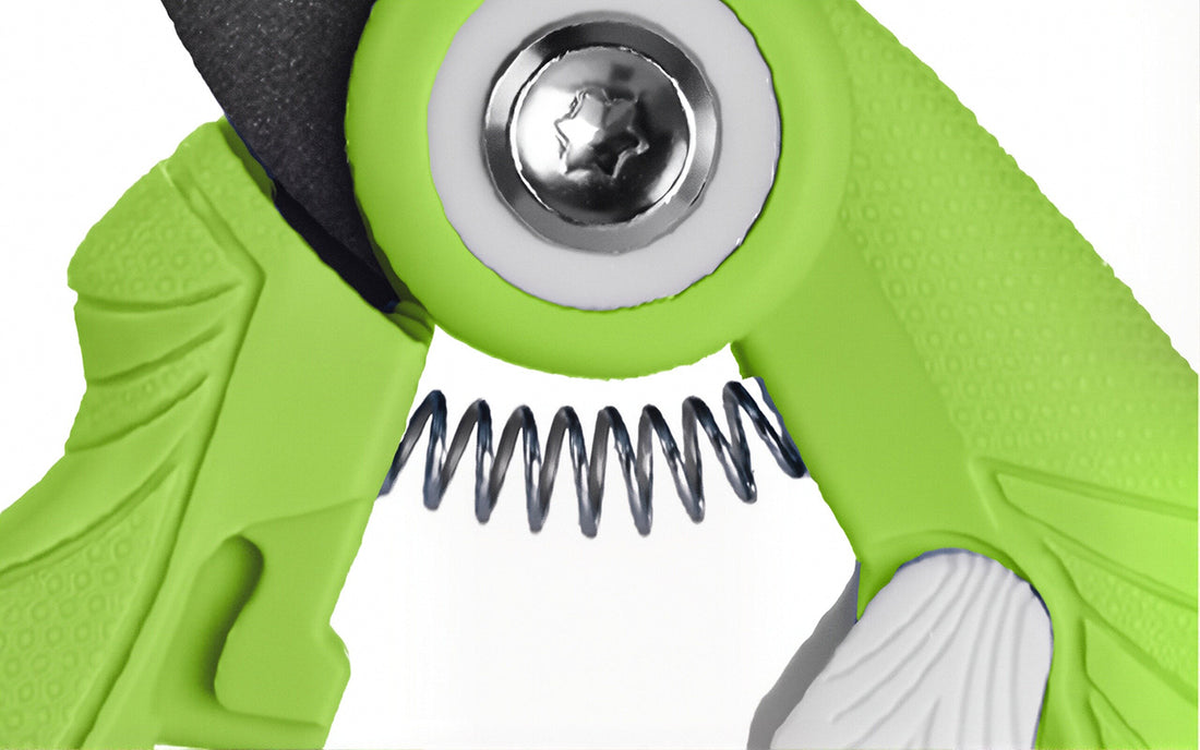 Green plastic tool with metal screw head and spring coil, close up showing innovation and quality