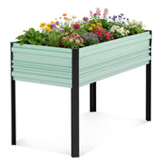 Mint-green raised garden bed planter box with black legs filled with colorful flowers