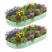 Two mint green raised garden bed planters filled with colorful flowers and herbs.