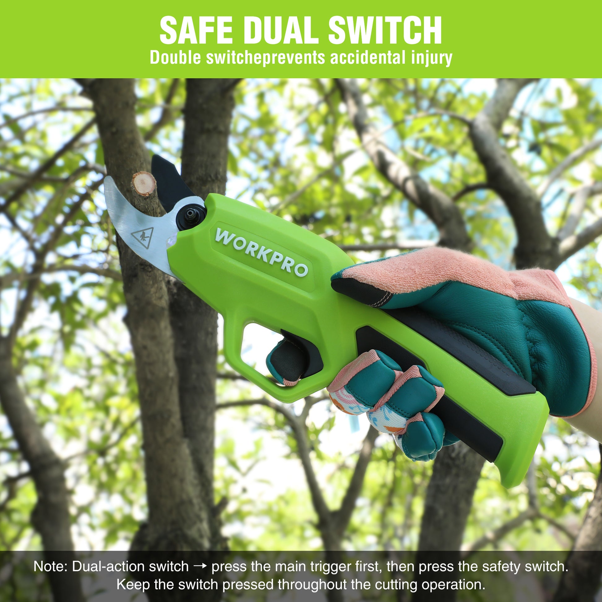 Green pruning shears with safety handle and dual switch, held near tree branches