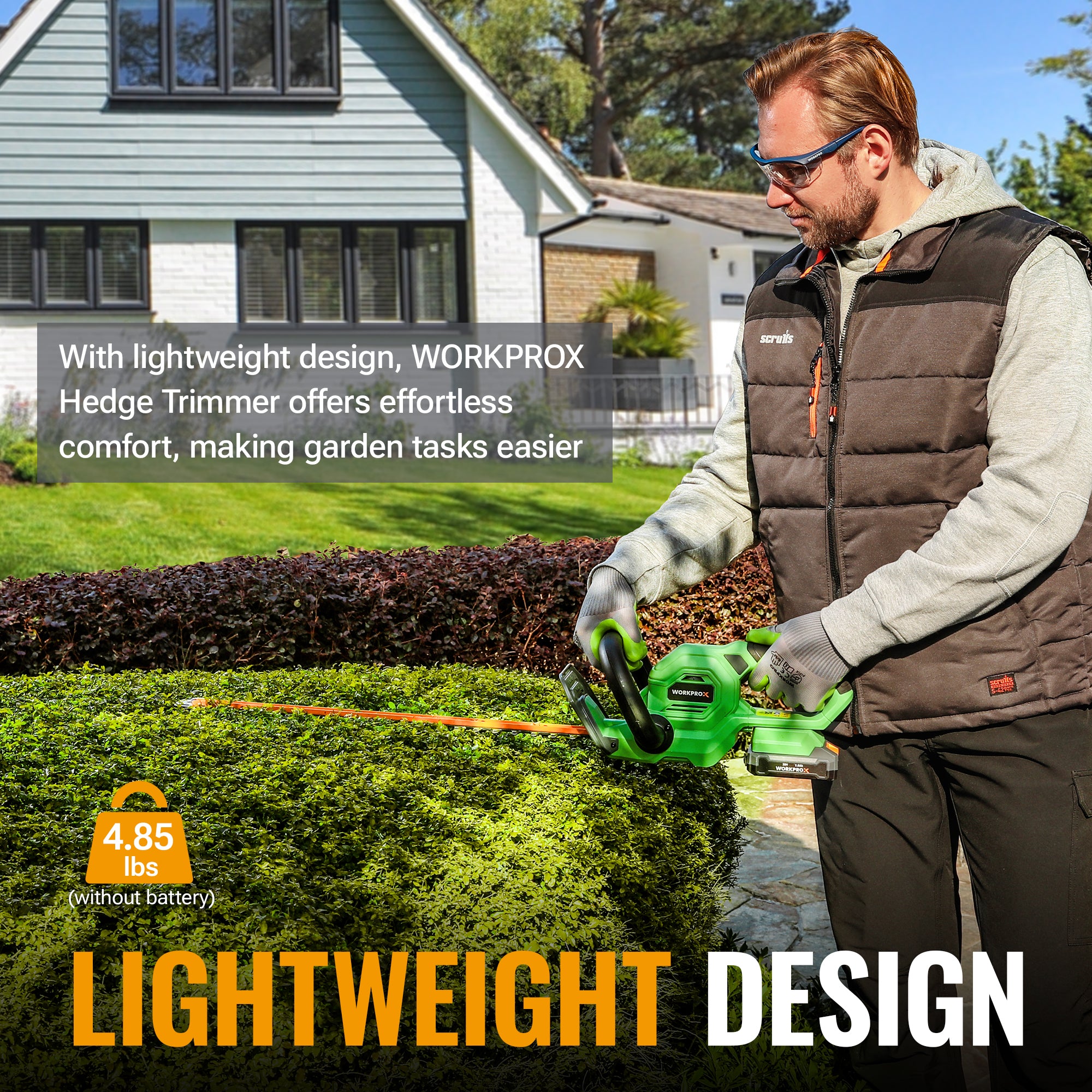 Green lightweight hedge trimmer held by gardener for trimming shrubs