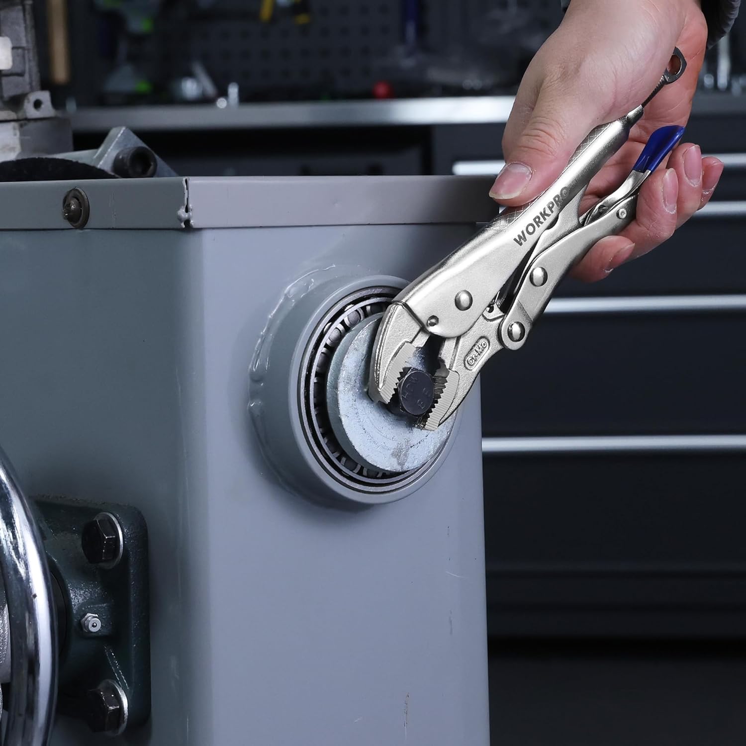 WORKPRO locking pliers clamping a wheel hub with curved jaws and blue handle