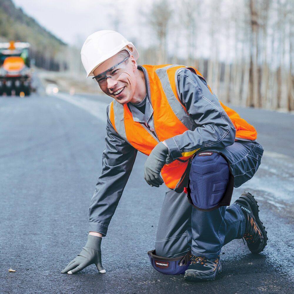 WORKPRO knee pads in orange and gray with dual adjustable straps for construction work on hard surfaces