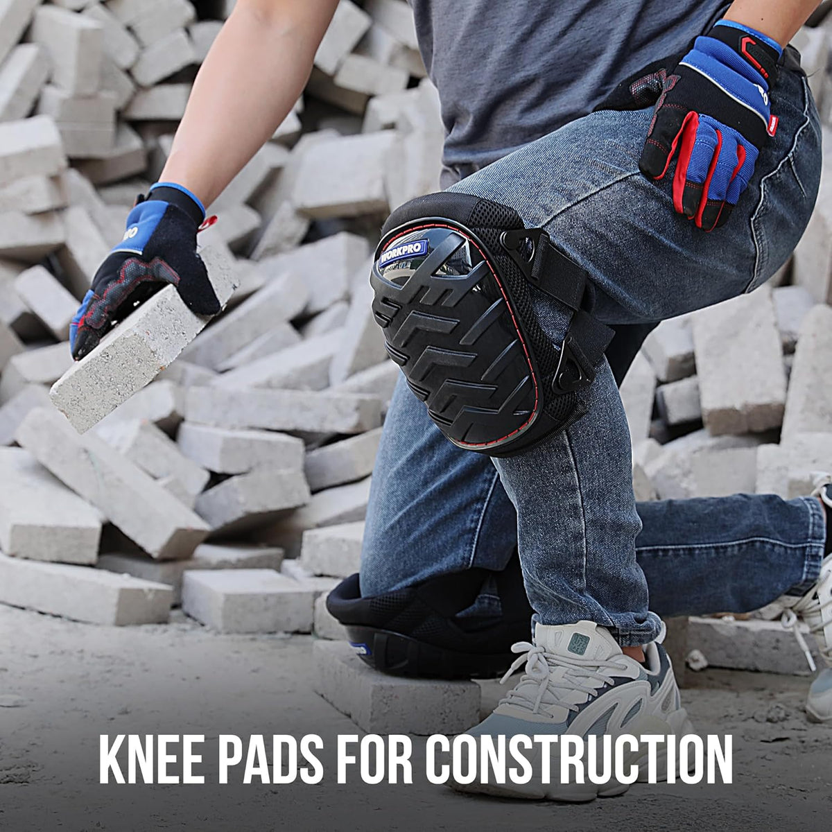 Black knee pads with red piping and adjustable straps, worn while kneeling at work.