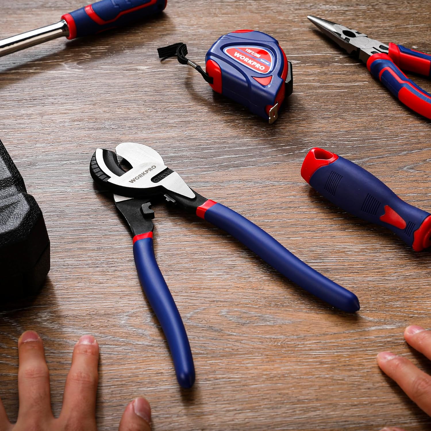 Cable cutter with blue handles and red accents on a workbench