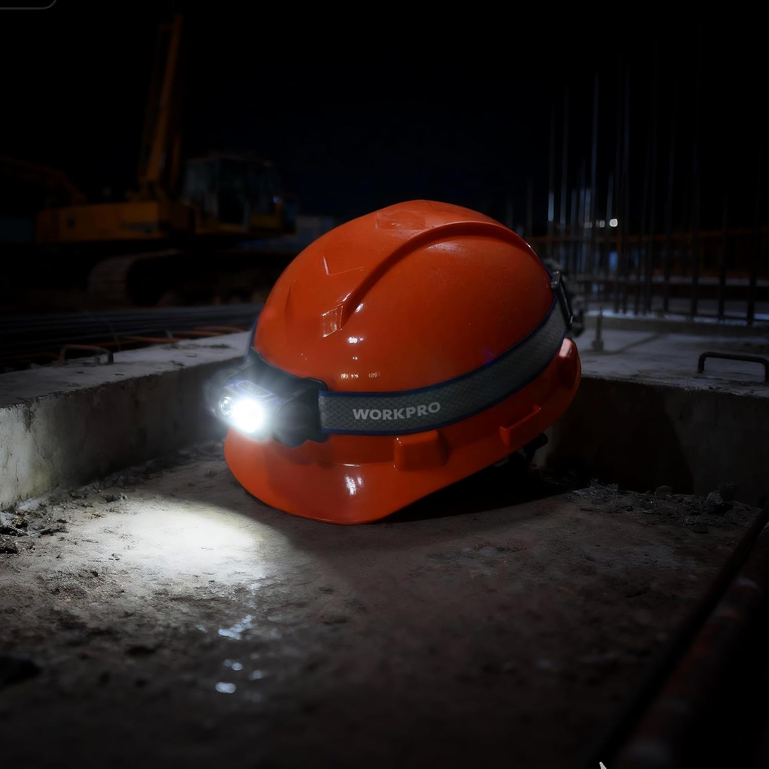 Orange hard hat with blue headlamp; compact LED light shines in dark