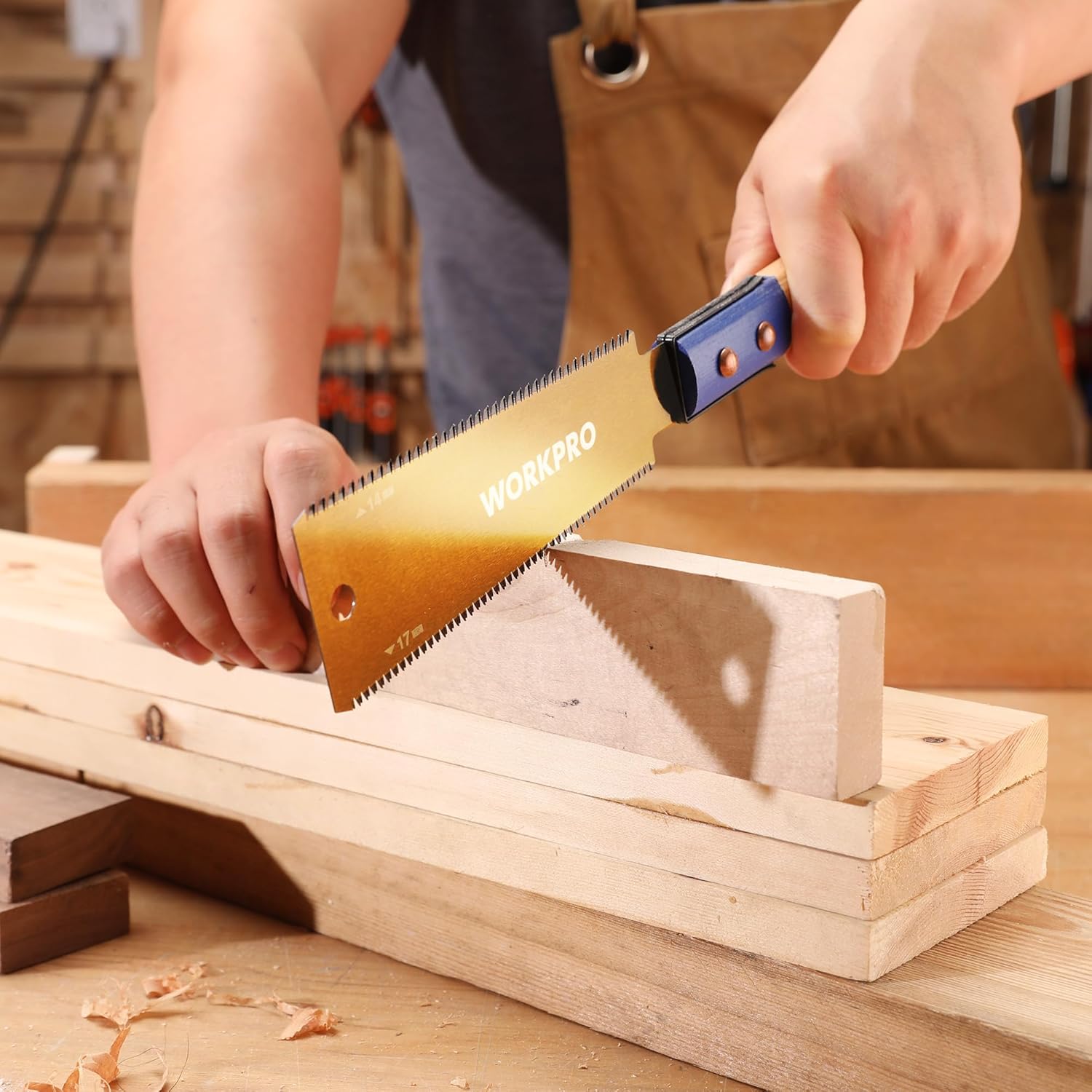 Japanese pull saw in use cutting wooden plank; blue beech handle with blade