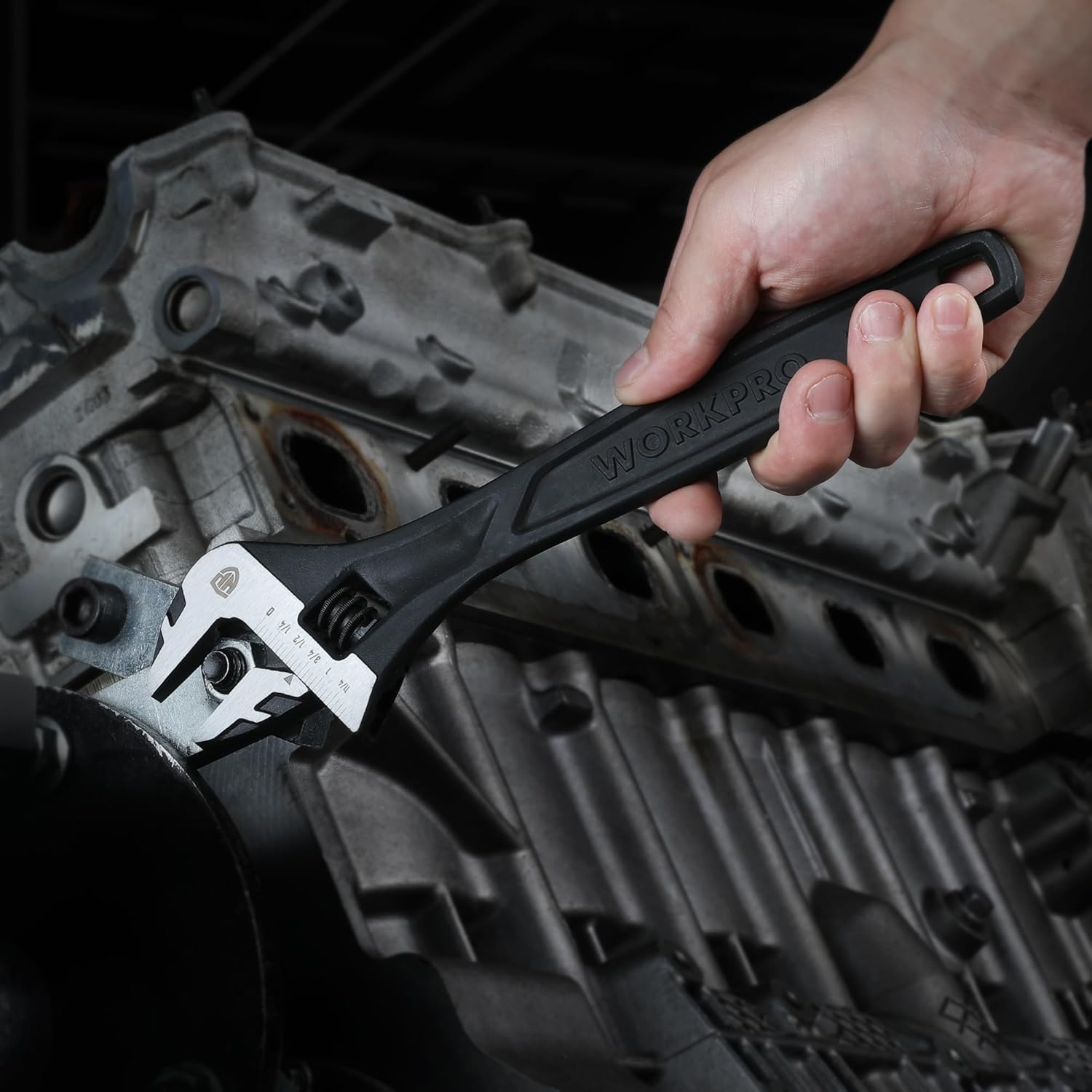 Adjustable wrench in hand using the screw on the jaw to fit a fastener