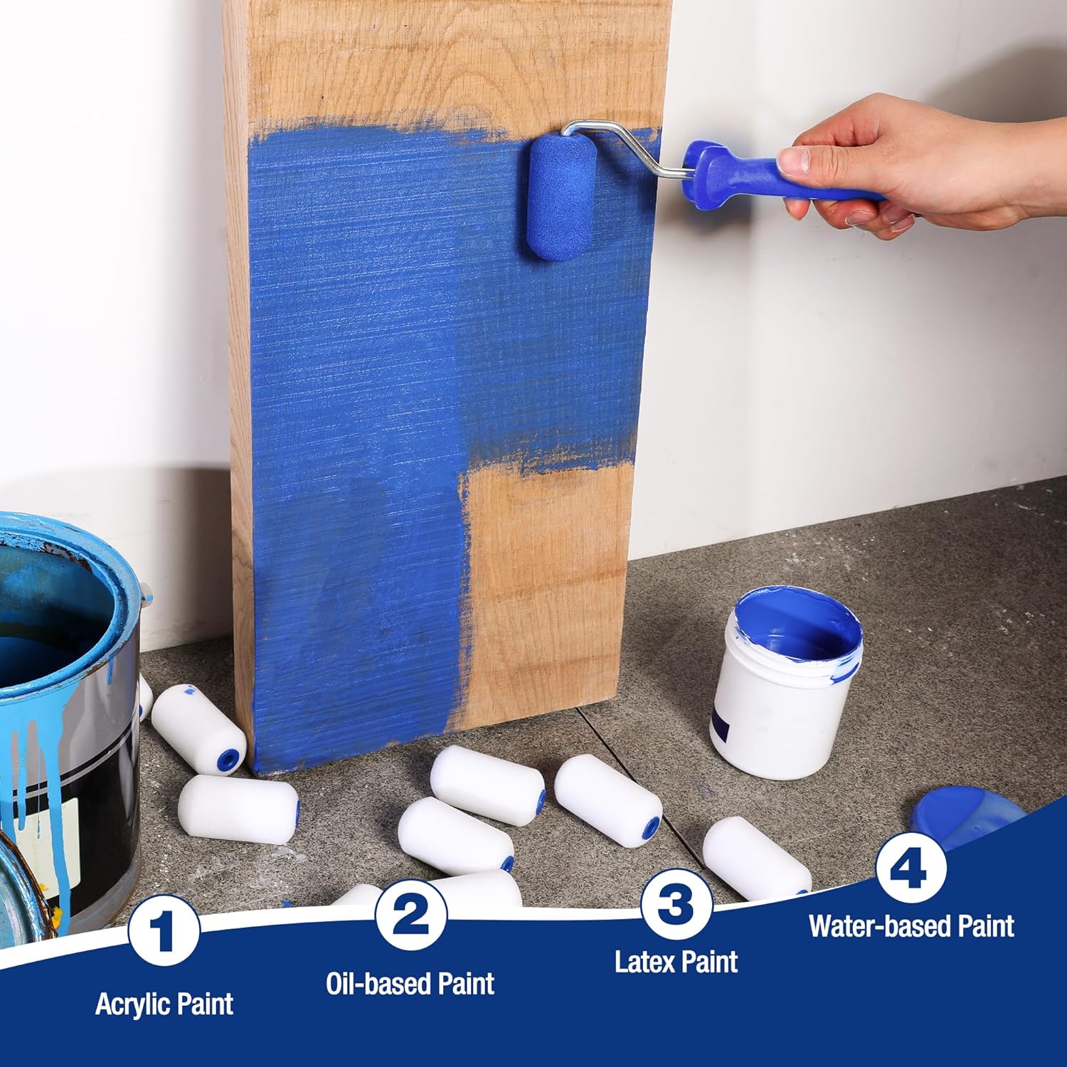 Mini foam paint roller cover applying blue paint to a narrow edge on wood panel.