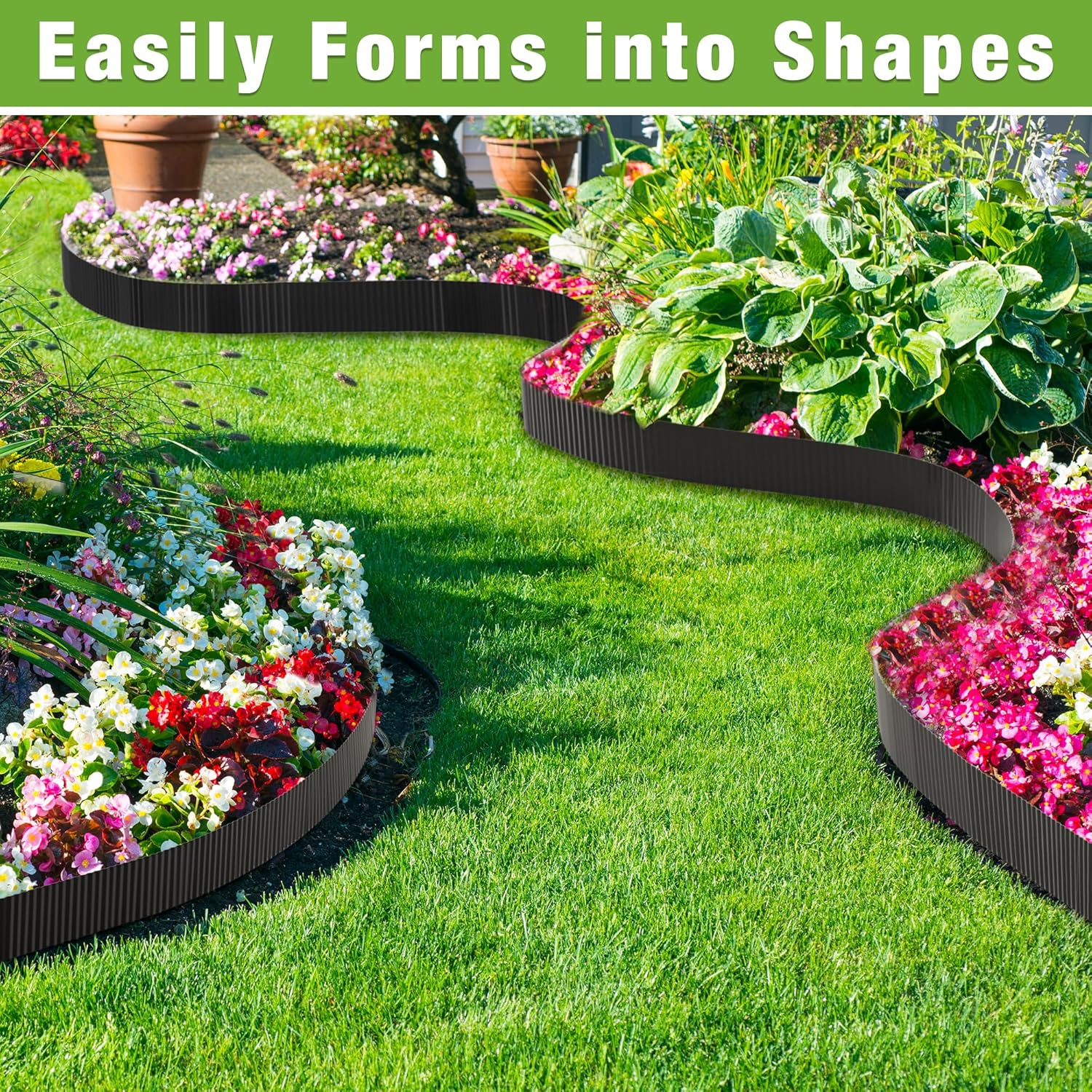 Black landscape edging formed into rounded shapes around flower beds on green grass.