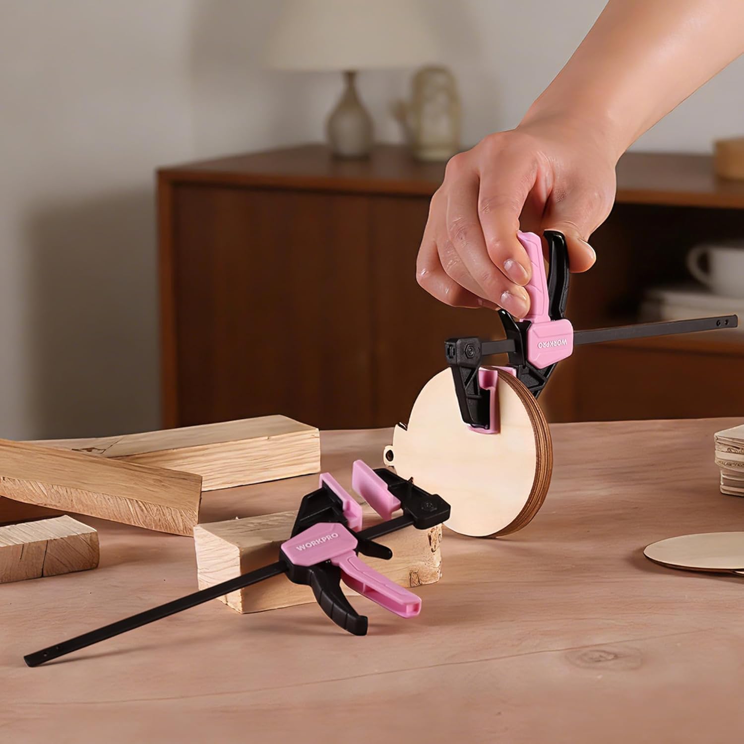 Pink mini bar clamp set on wood pieces with black handles and release tabs