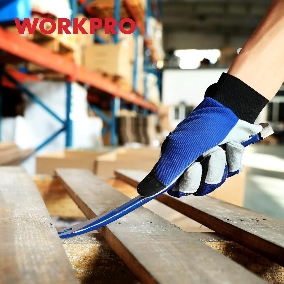 Gloved hand using a blue WORKPRO nail puller to pry wood during remodeling