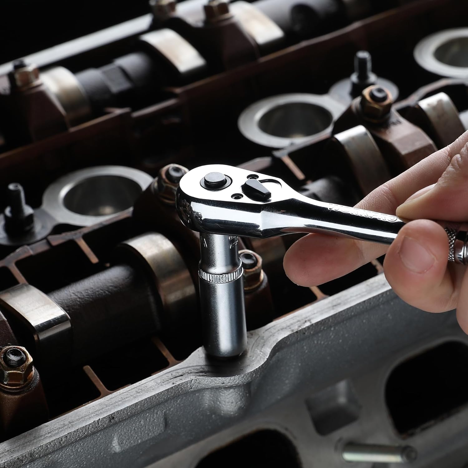 Chrome 1/4-in drive ratchet wrench being used with socket in toolkit
