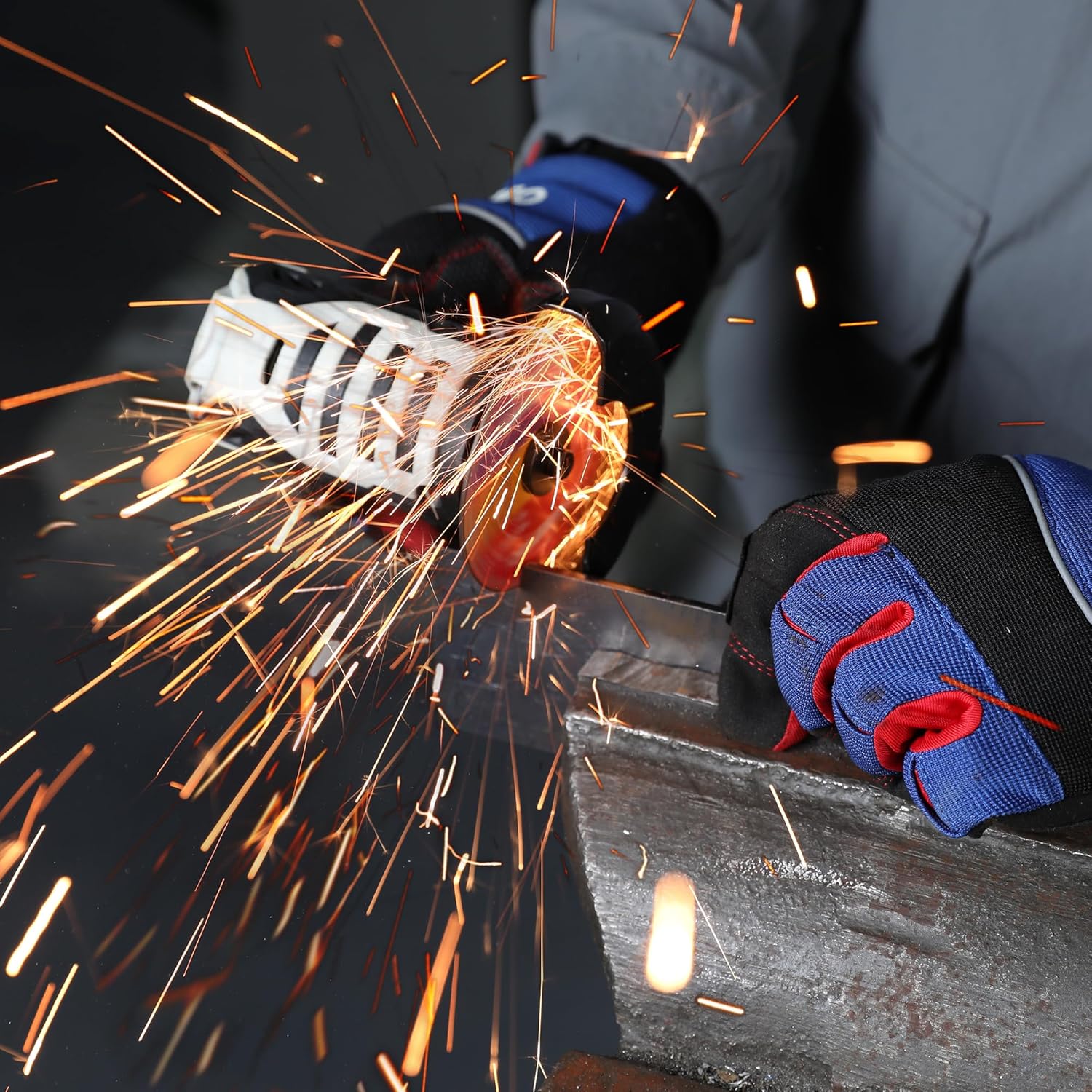 Angle grinder cutting metal with a thin cut-off wheel, bright sparks and gloves