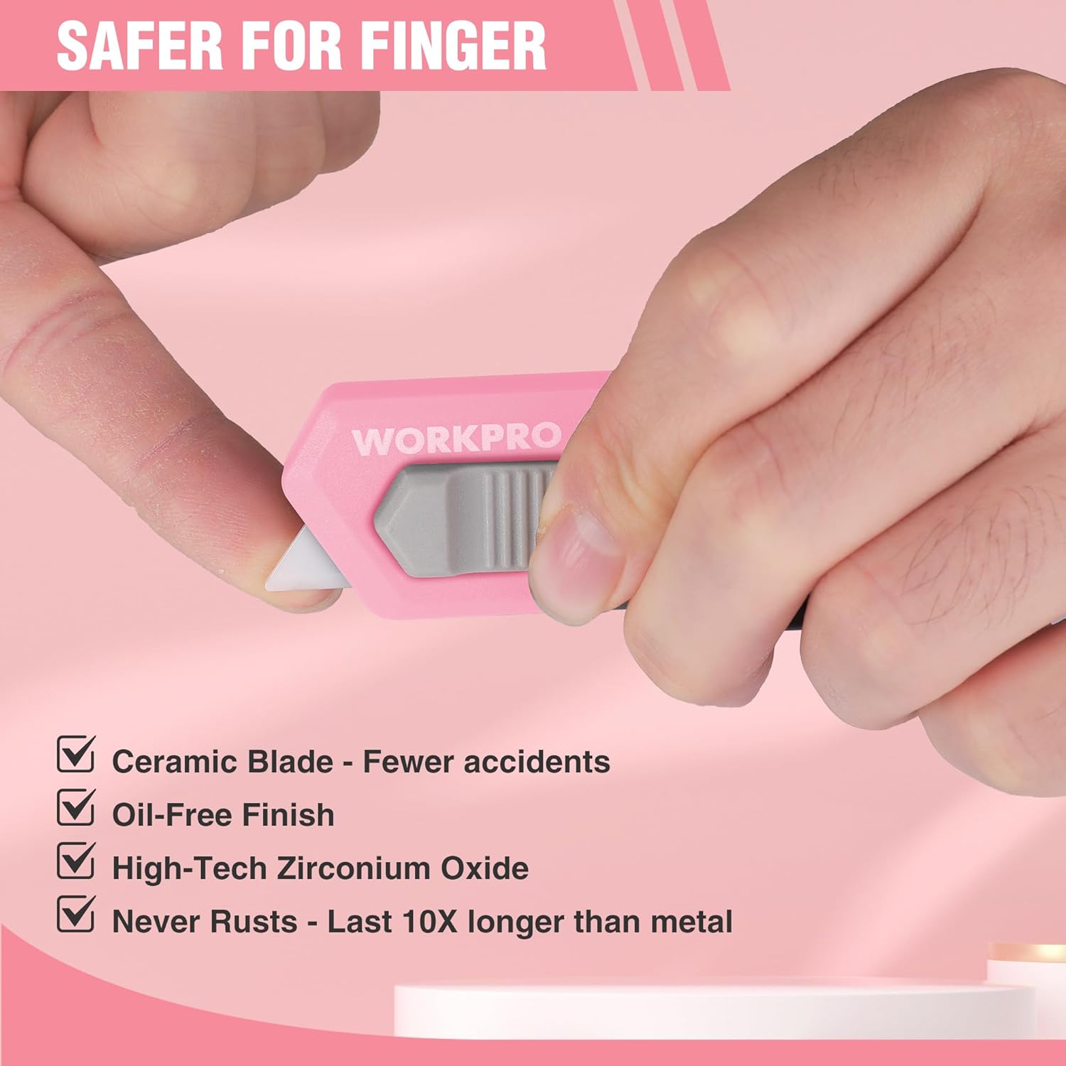 Pink ceramic blade safety box cutter with finger-safe handle and exposed blade tab