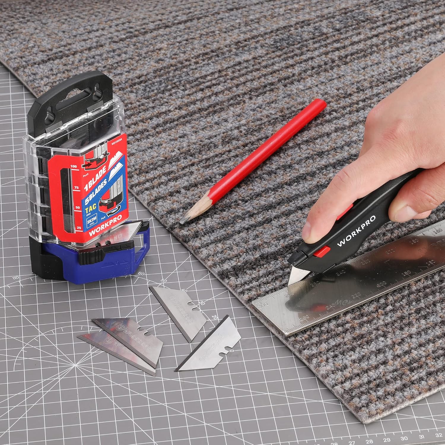 Utility knife blades in clear dispenser and spare blade on cutting mat